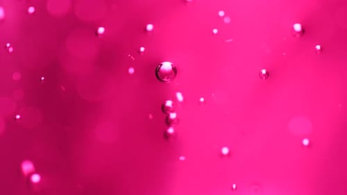 Abstract science or art background with pink bubbles rising