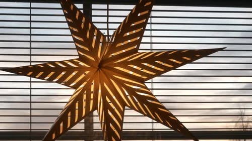 Christmas Star Decoration Hanging in Window with Blinds