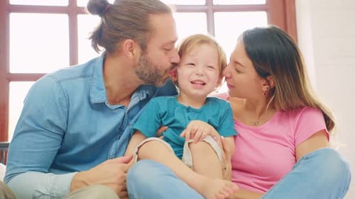 Loving Family Embracing and Kissing Indoors