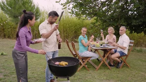 Friends Gather for Backyard Barbecue on Sunny Day