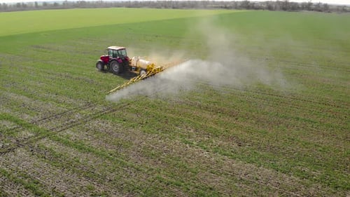 Farmer on Tractor and Sprayer with Natural Eko Fertilizer with Liquid Manure Processes Field