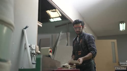 Carpenter is working at workshop.