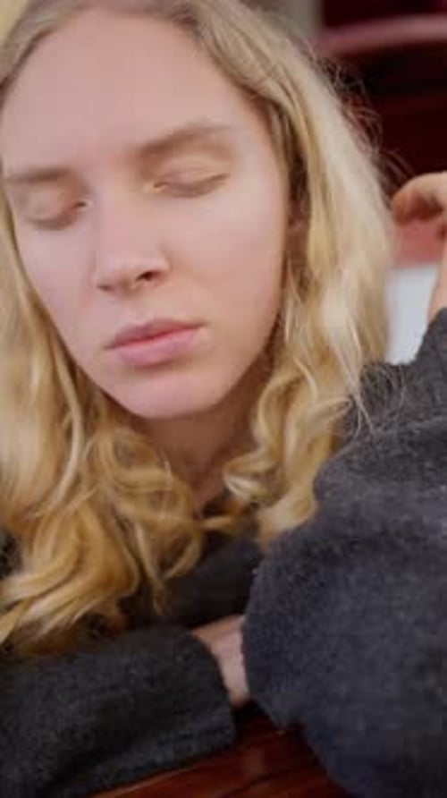 Blonde Woman Resting with Eyes Closed Indoors