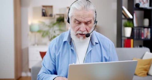 Senior Man Video Call on Laptop at Home