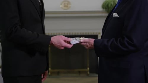 Money in politics - close up handshake and money transfer HD