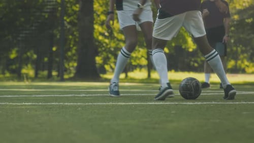 Boys Playing Soccer on Grassy Field