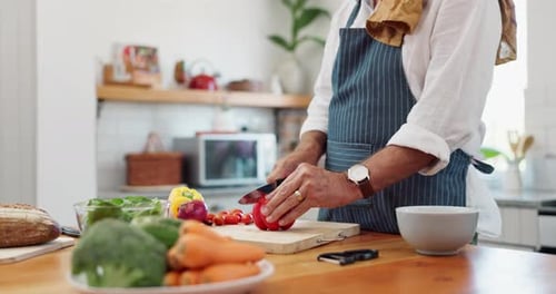 Senior Adult Chopping Vegetables in a Kitchen