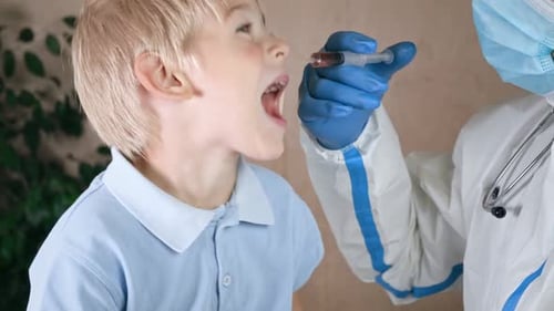 Doctor Giving Medicine to Blonde Hair Boy