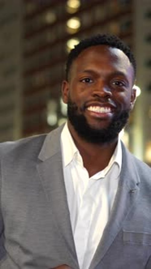 Smiling Man Wearing Gray Suit Jacket at Night