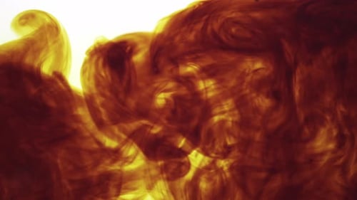 Swirling Brown and Yellow Ink on White Background