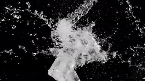 Ice Cubes Collide with Water Splash on Black