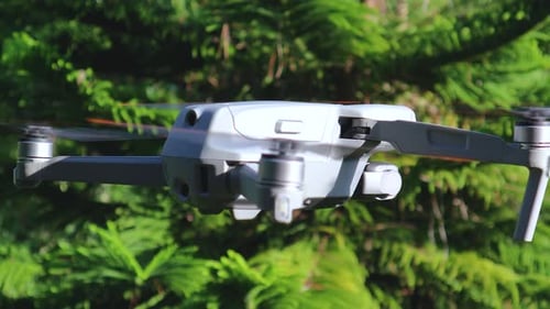 Drone quadcopter flying and turning around, spying, surveillance and aerial photography