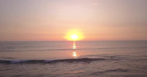 Golden Sunset Over Ocean Waves with Reflections