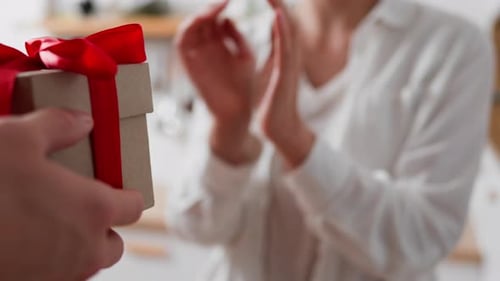 Woman Receives a Gift with a Red Ribbon
