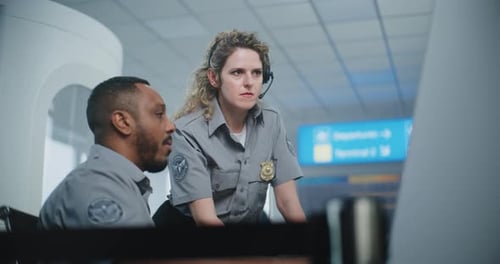 Security Officers Discussing Information on a Computer Screen