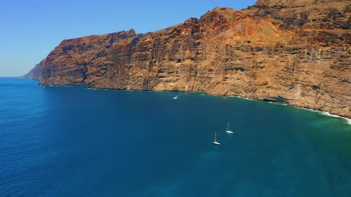Seascape with huge rocks in deep blue Atlantic Ocean at sunny vivid day. Spectacular view of tranqui