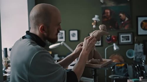 Male Sculptor is Modeling Clay Figurine of a Naked Female Body in a Creative Potting Garage Studio