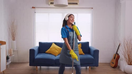 Woman Dancing While Cleaning With a Mop