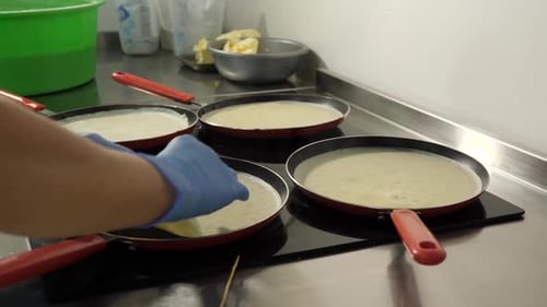 Cooking Pancakes in Multiple Pans on Stove