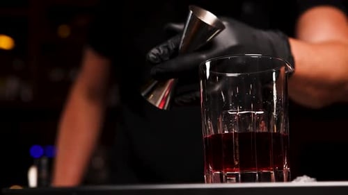 the bartender prepares a cocktail at the bar