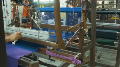 Hand Weaving Making Colorful Silk Fabric on Wooden Loom in Traditional Silk Factory Chiang Mai
