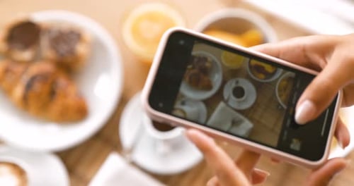 Woman Takes Photo of Breakfast with Smartphone