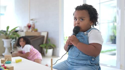 Young Child Speaking Into Microphone