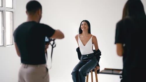 Professional Photoshoot Model Posing for Photographer in White Studio