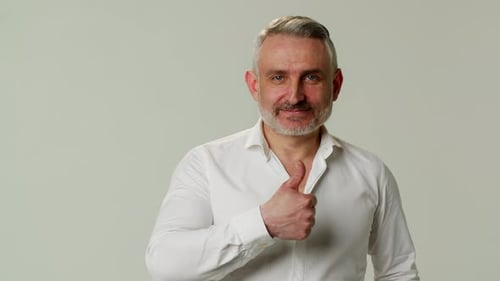 Man Smiling and Giving a Thumbs Up