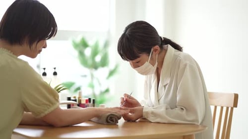 Woman Getting Manicure in a Salon Setting