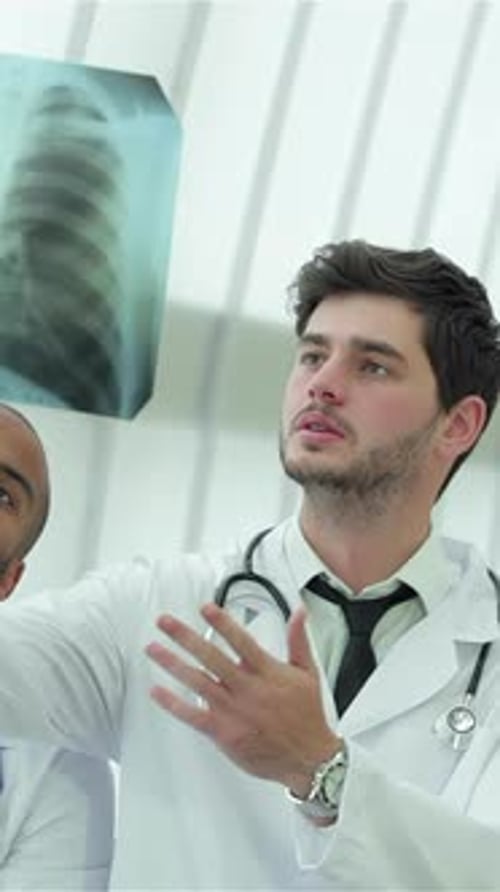 Three Confident Doctors Analyzing an Xray of Lungs in a Modern Hospital