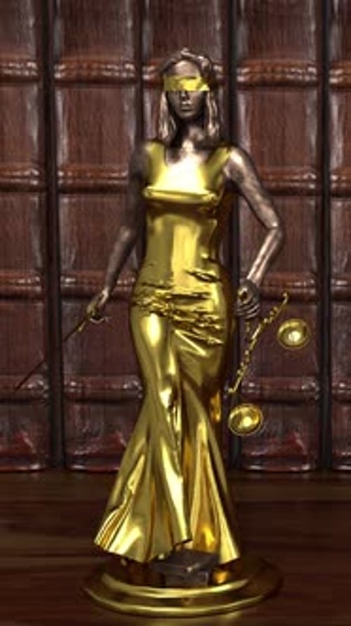 Blindfolded Lady Justice statue holding golden scales in courthouse setting.
