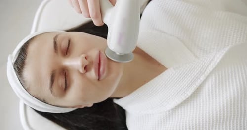 Woman Receiving a Facial Treatment at Spa
