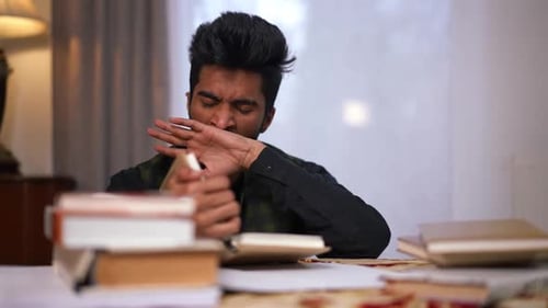 Exhausted Middle Eastern Adult Male Student Yawning Falling Asleep on Table Indoors Zoom in Portrait