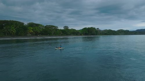 Athlete Kayaking Along Sea Coast
