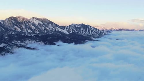 Sunrise above the clouds flying Boulder Flat Irons freezing cold winter orange drone aerial Colorado