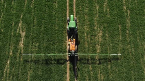 Green Tractor at Work in Field