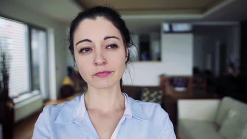 Thoughtful woman in the bright interior room looks around