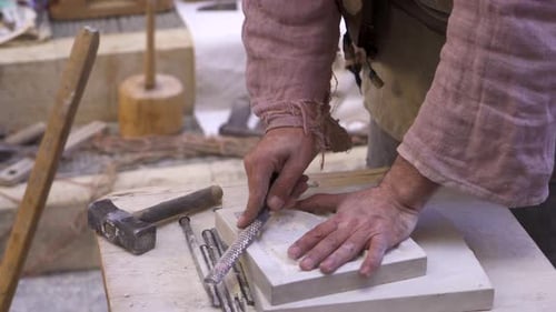 Sculptor stone carving a stone. Professional craftsman, an artist working manually.