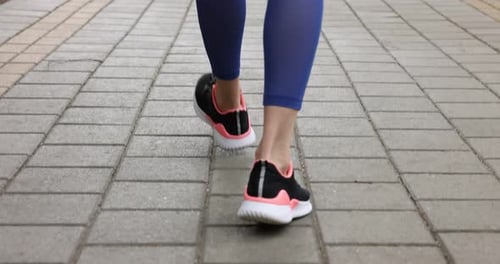 Woman suffering from leg pain during workout outdoors, closeup