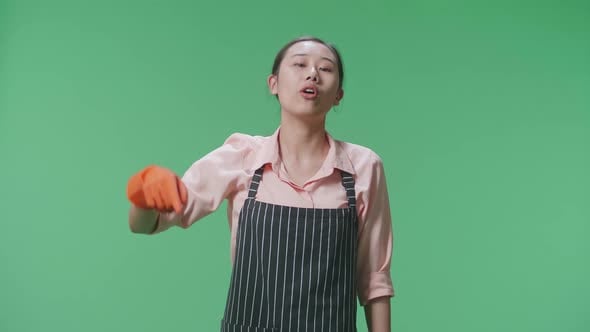 Angry Asian Female Housekeeper Pointing And Shouting In The Green ...