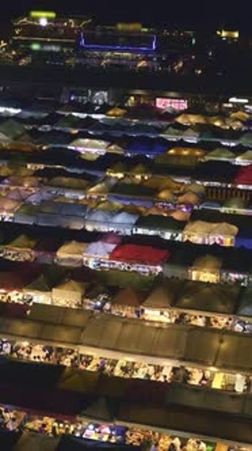 Aerial Panning of Colorful Asian Market Tents and Food Stalls at Night