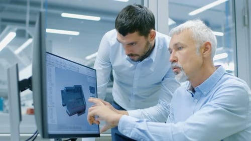 Industrial Designer Has Discussion with Senior Engineer While Working in CAD Program, Designing New