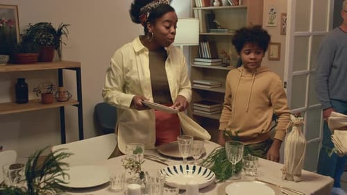 Family Prepares Dinner Table for Gathering