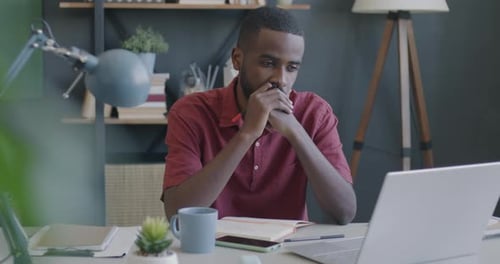 Portrait of Pensive African American Man Entrepreneur Thinking Looking at Laptop Screen in Office