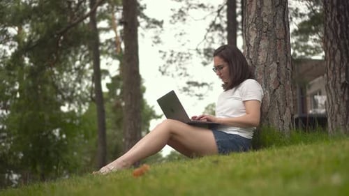 Woman Works on Laptop in Nature Setting