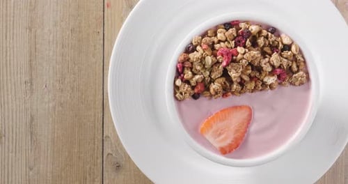 Composition of a typical genuine breakfast made with strawberry yogurt and granola. Concept of: fi