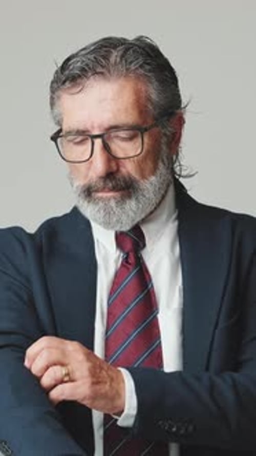 Formally Dressed Man Adjusts his Suit Cuff