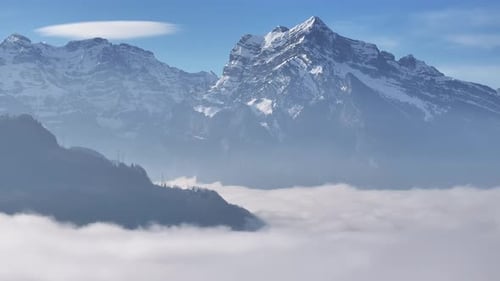 Spectral cap cloud over Swiss alpine peak