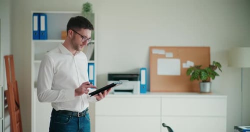 Man Using Tablet with Stylus in Modern Office